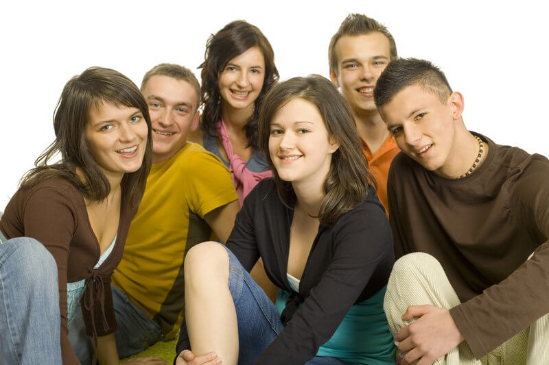 Group of teen fisting a boy